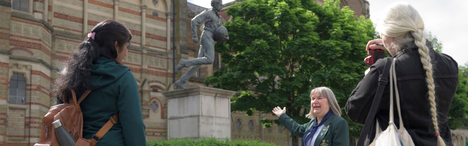 A tour of Rugby looking at a statue of William Webb Ellis