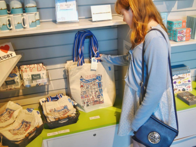 Image of a woman looking at bags in a shop